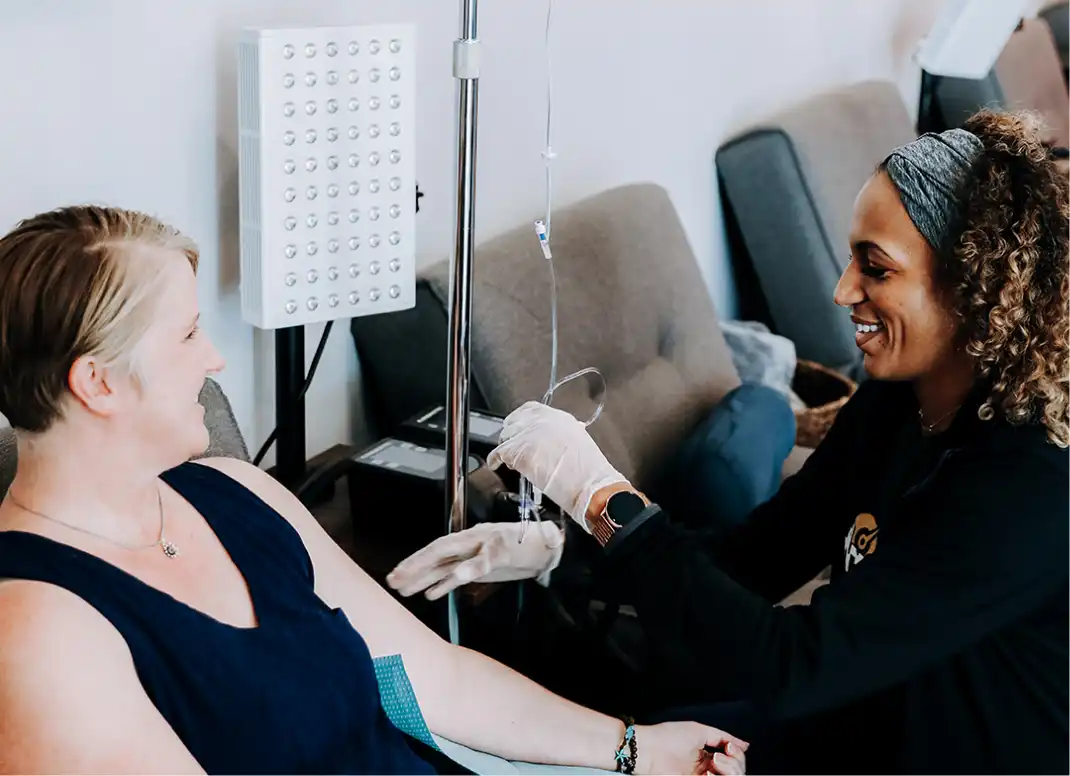 Nurse readies client for IV Drip Therapy at Restore Hyper Wellness