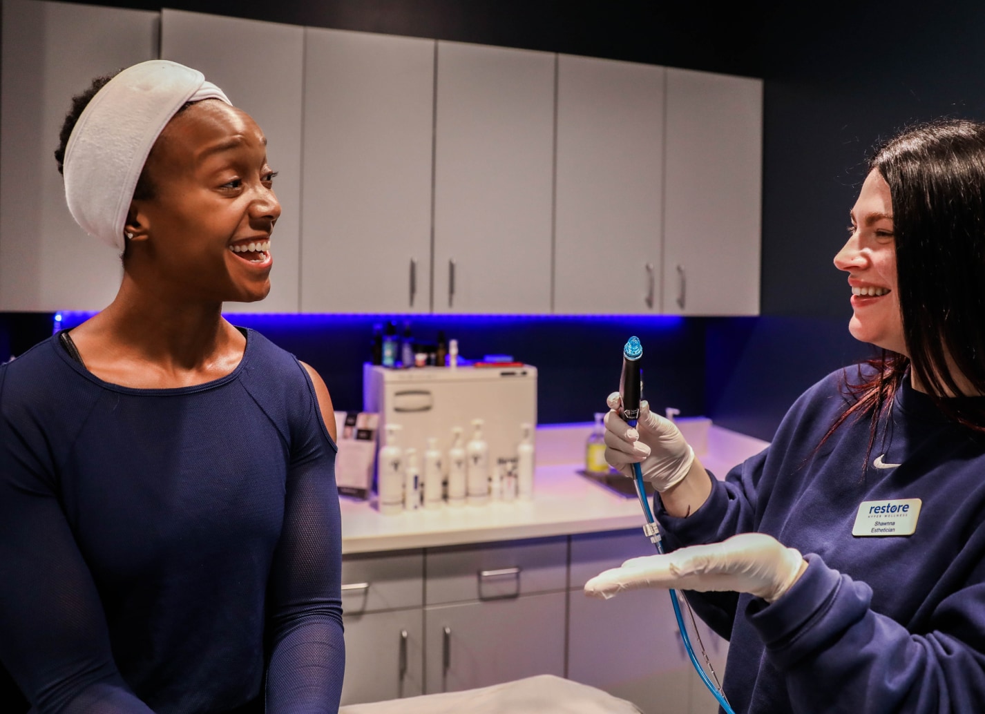 Esthetician talks about what is a hydrafacial to customer.