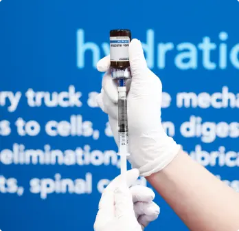 Hands of a nurse drawing an NAD+ intramuscular injection shot.