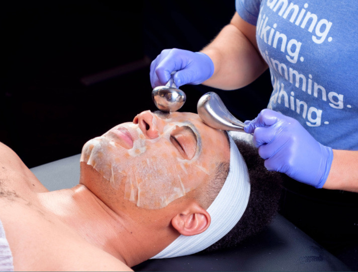 Image of a person using Cryo Globes during a Vitamin C Brightening Facial at Restore Hyper Wellness.