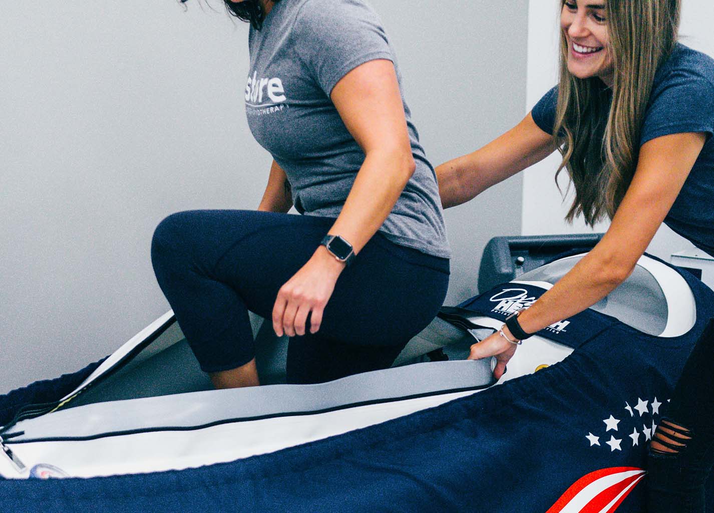Customer stepping into the mild hyperbaric oxygen chamber.