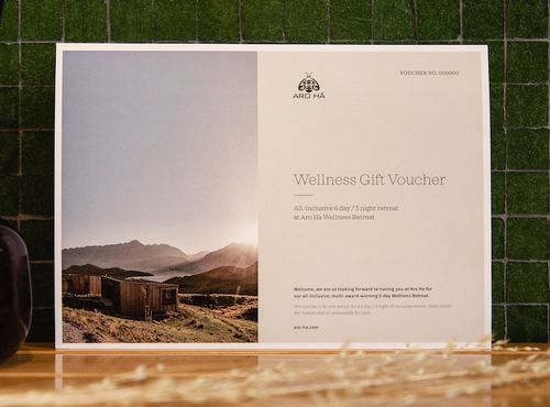 A printer A4 gift voucher on a wooden table.