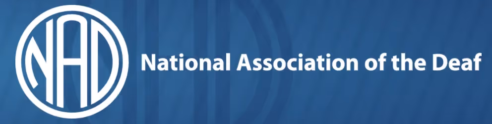 The logo of the National Association of the Deaf (NAD), featuring a stylized white monogram “NAD” inside a circular emblem, set against a deep blue background with the text “National Association of the Deaf” to the right in bold white letters.