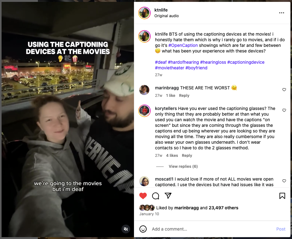 A smiling young woman stands next to her partner in a parking garage at night, holding up a peace sign. The on-screen caption says, “we’re going to the movies but I’m deaf.” Text overlay reads “Using the captioning devices at the movies.” The Instagram caption shares her frustration with closed captioning devices and preference for open-captioned movie showings.