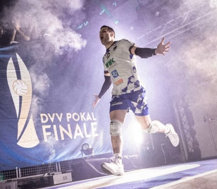 Ryan Manoogian runs through stage lights and smoke onto the court during player introductions.