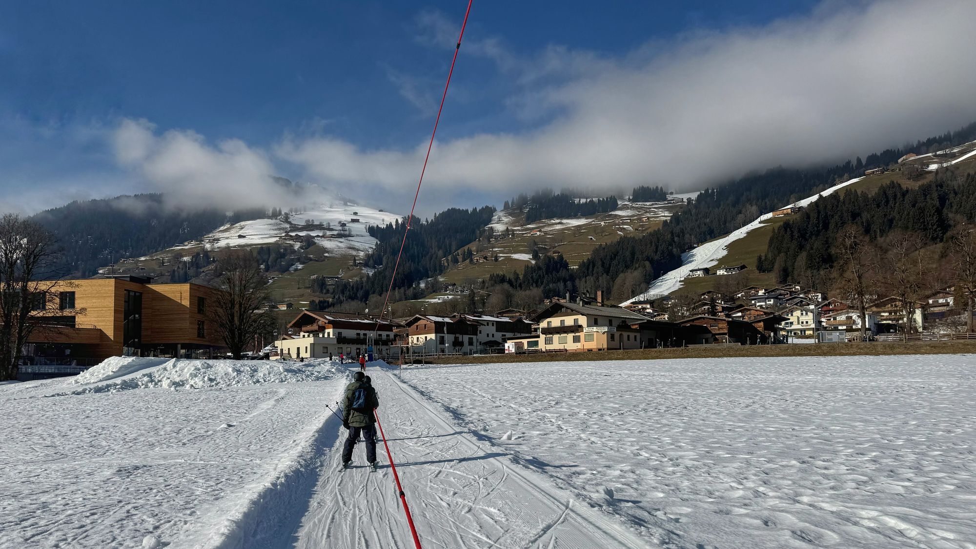 In tow in Brixen im Thale with the narrow red valley descent on the right in the background