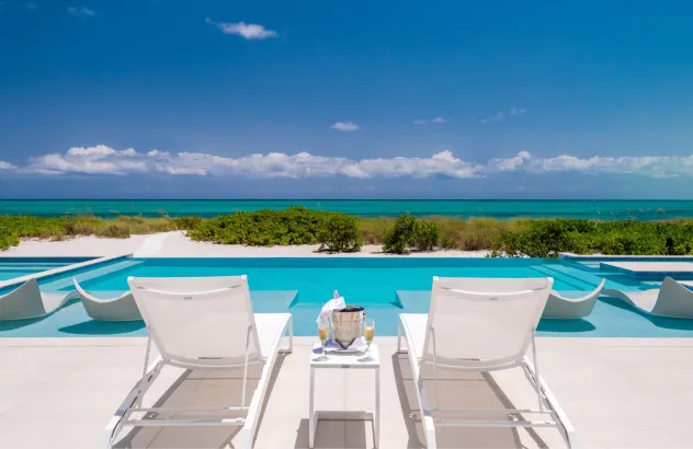 Pool deck with sun loungers and panoramic sea view
