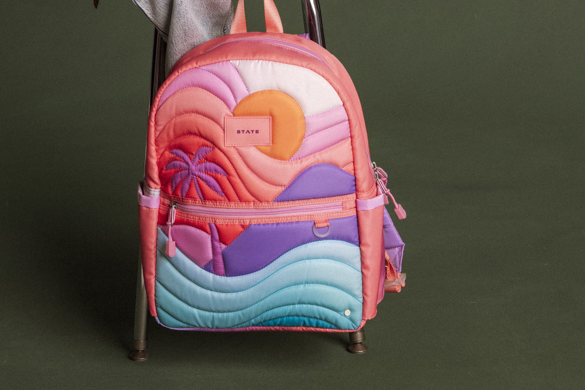 STATE backpack with sunset, palm, and wave design