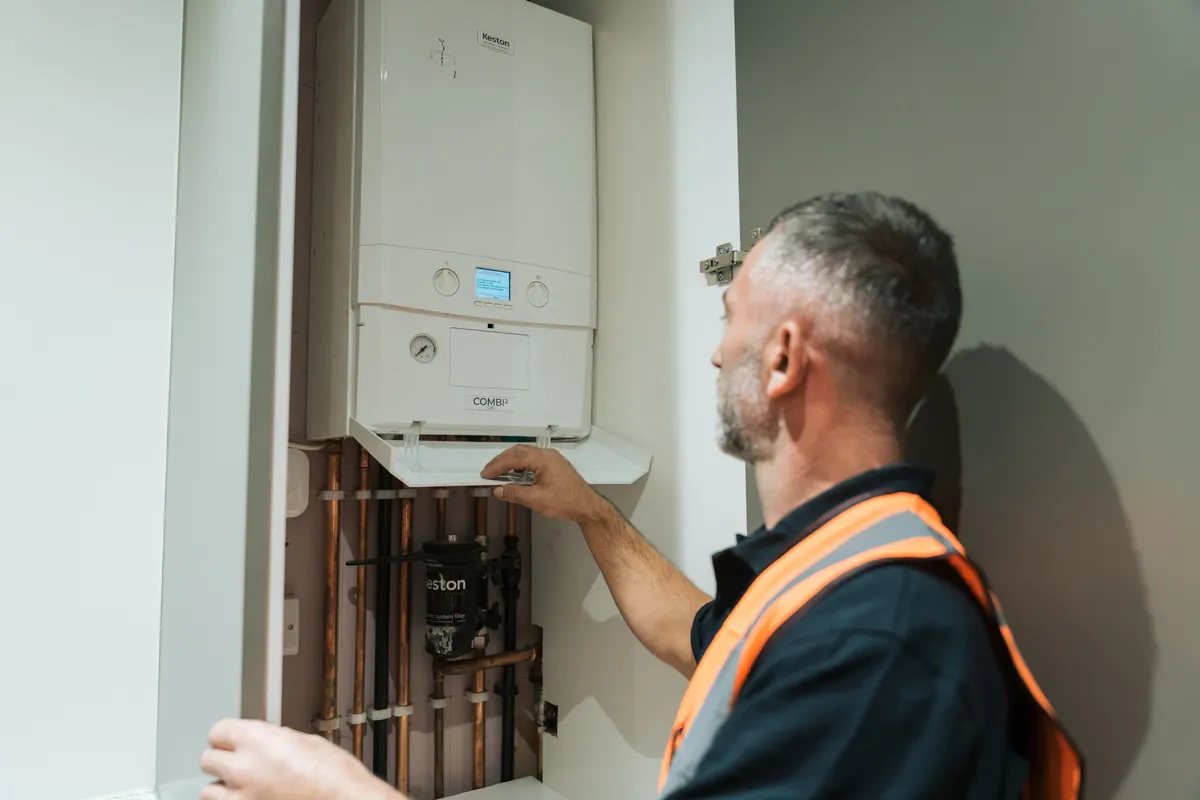 FS Group gas engineer working on a wall-hung boiler