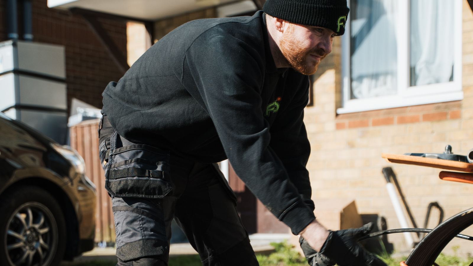 FS Group engineer working a drain camera reel in a front garden