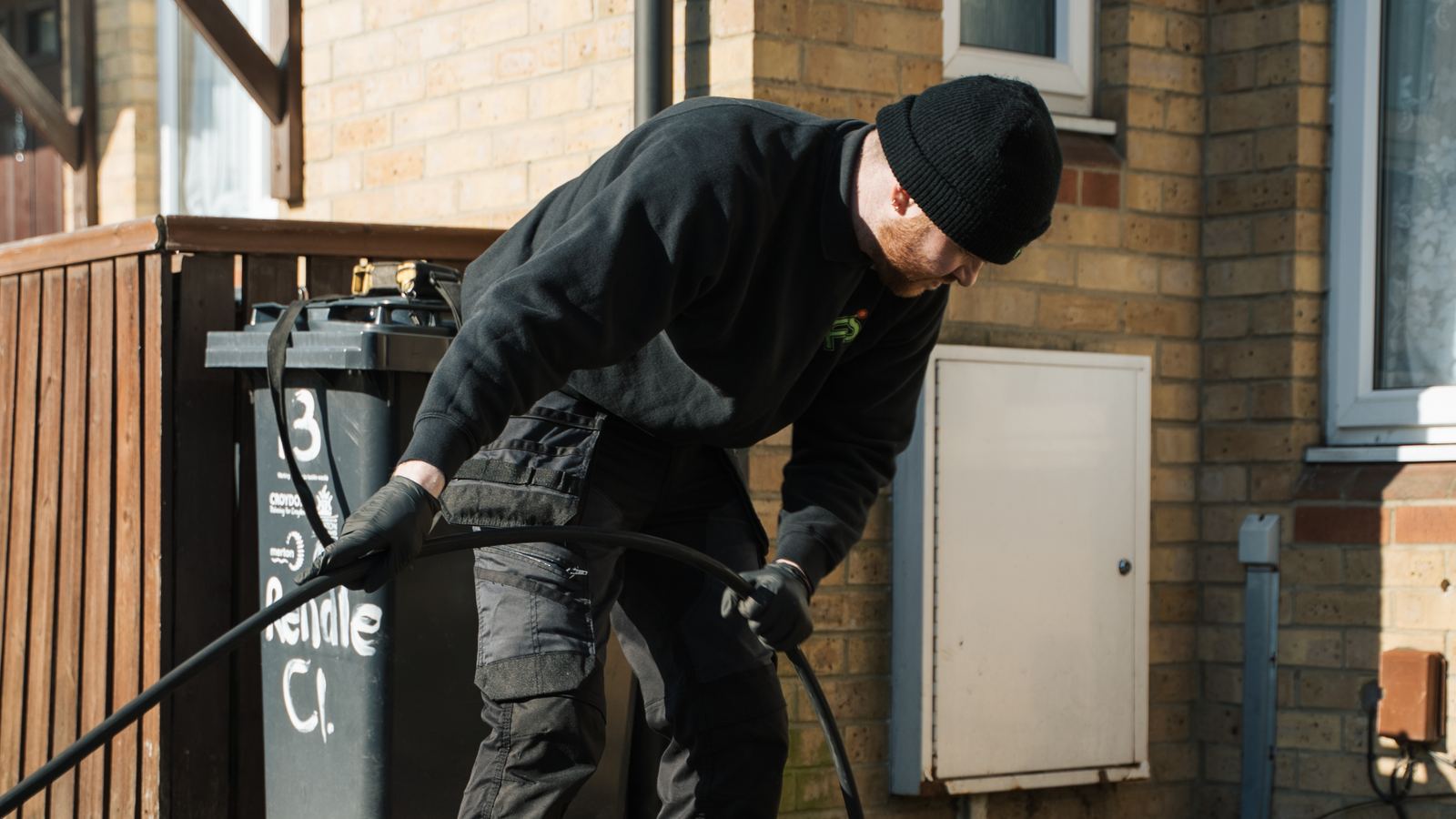 FS Group engineer rodding a drain outside a block of flats