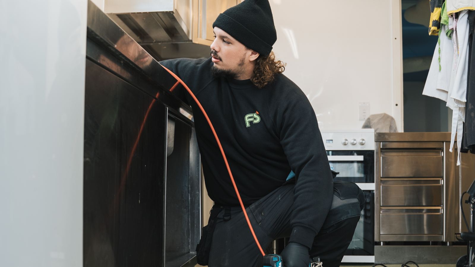 FS Group engineer clearing a drain in a commercial kitchen
