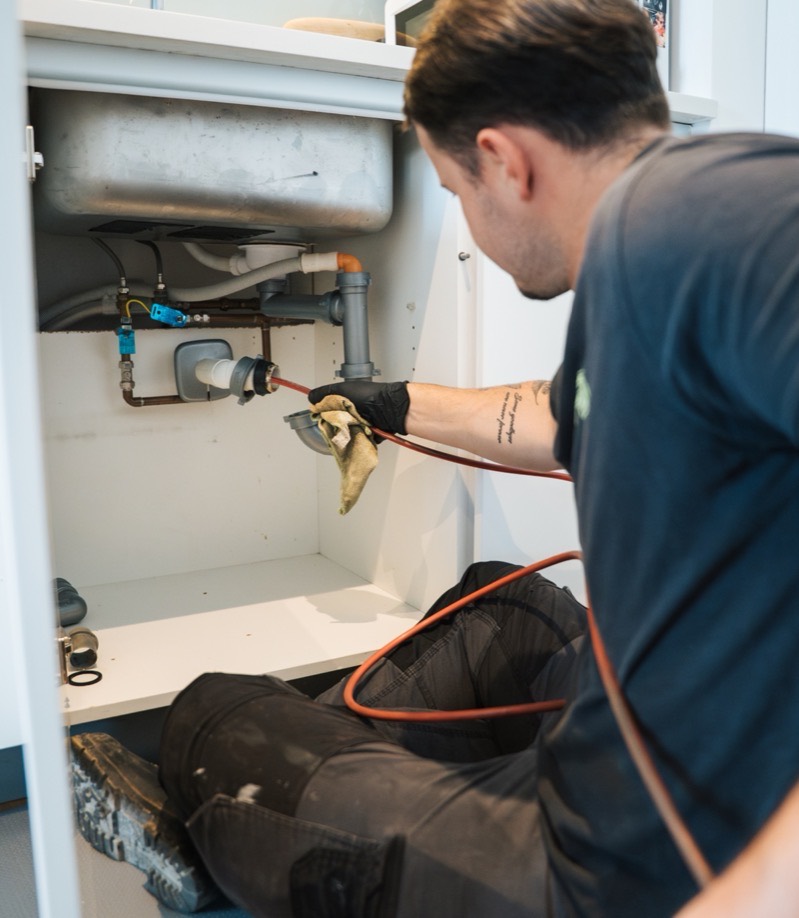 FS Group engineer feeding a drain cable into the sink waste