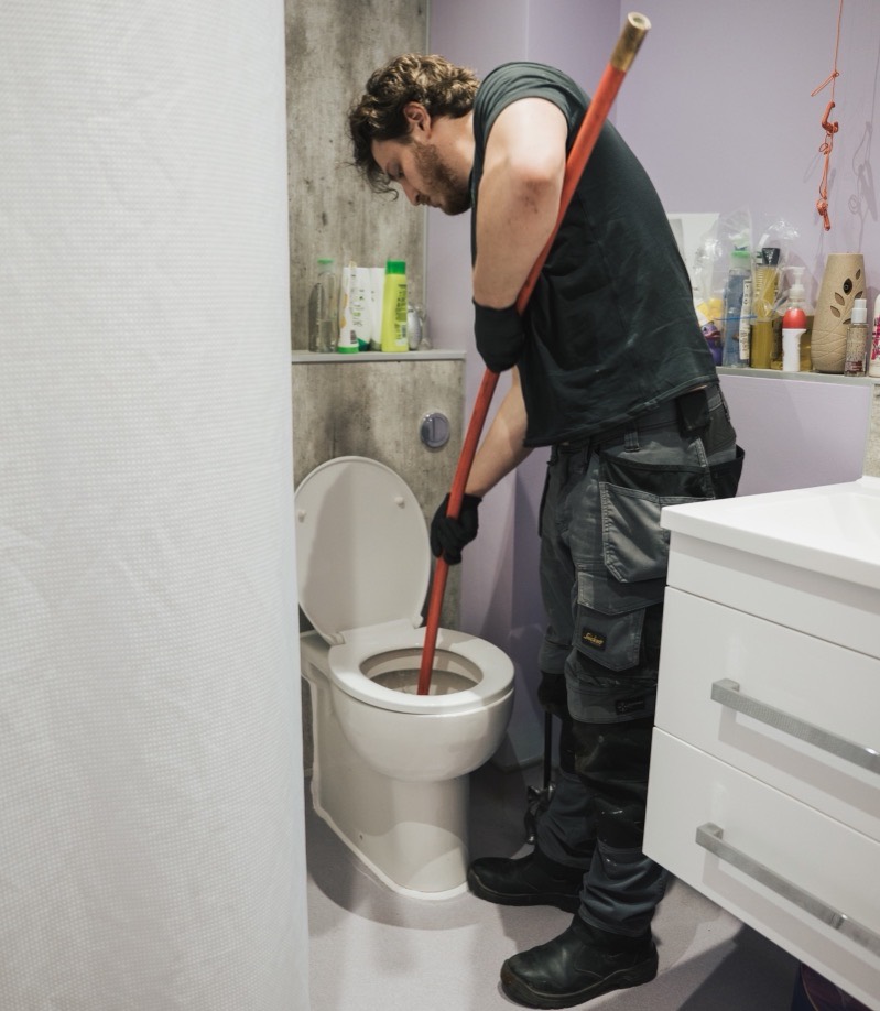 FS Group engineer rodding a blocked toilet