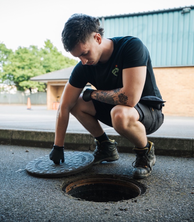 FS Group engineer checking an open manhole outside