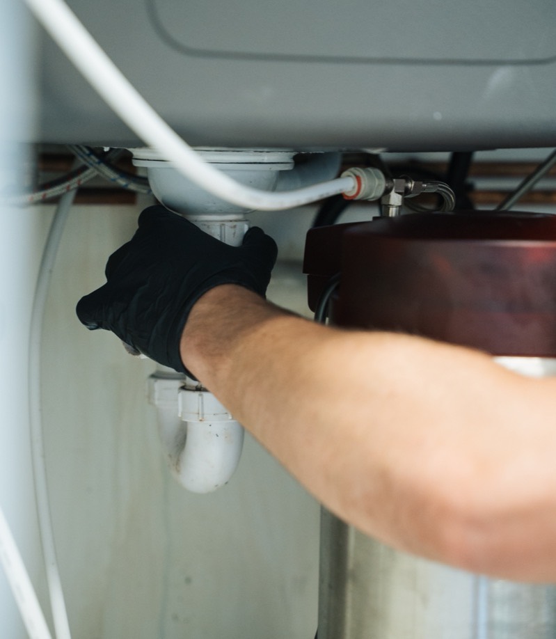 FS Group engineer checking the trap under a slow sink