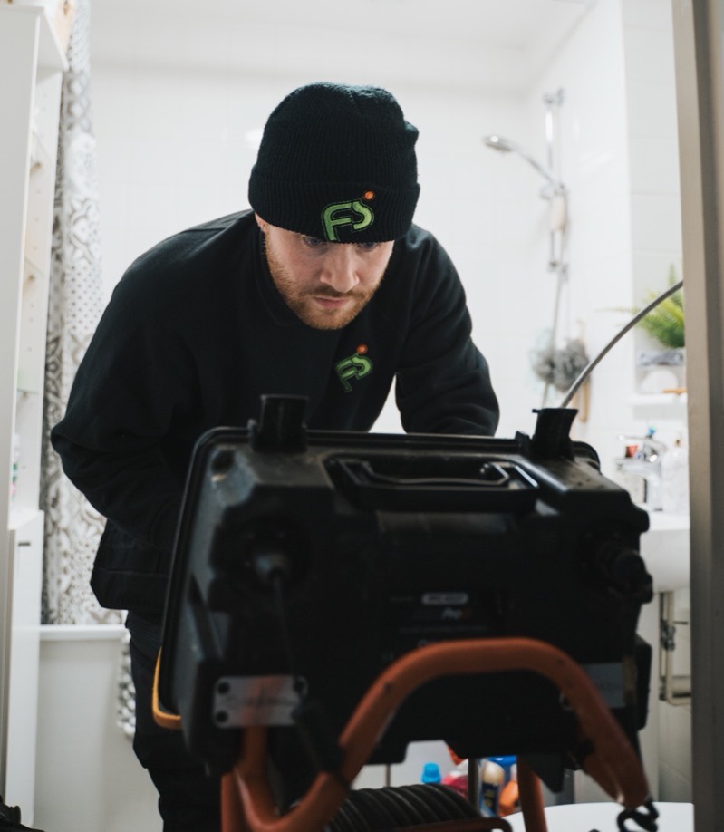 FS Group engineer running a drain camera survey in a flat