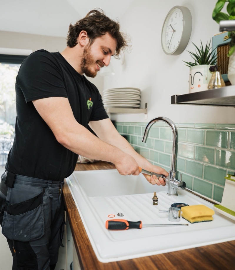 FS Group engineer working at a kitchen sink