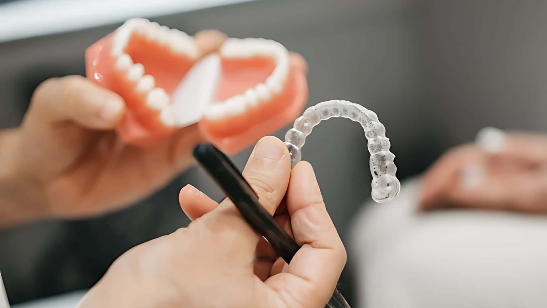 A lady putting in her Invisalign Lite Clear teeth Aligners