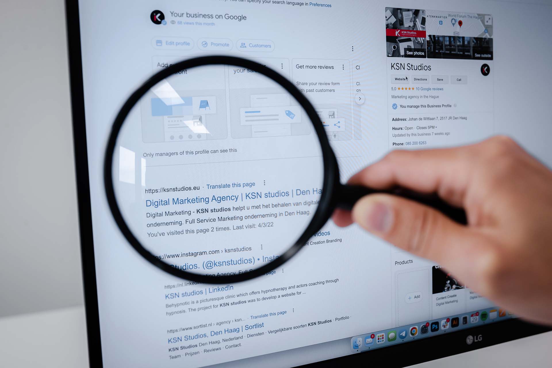 A magnifying glass in front of a laptop screen showing a SERP