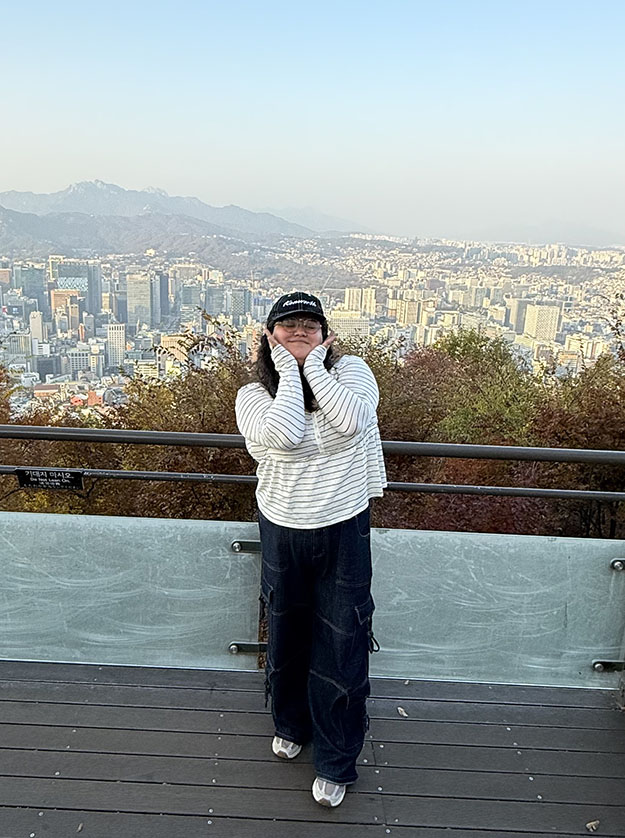 This a photo of me in front of a colorful mural.