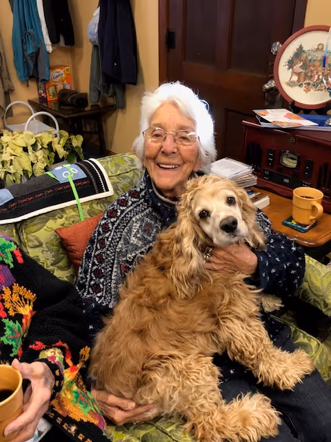A woman holding a dog in her arms
