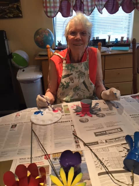 A woman standing in a kitchen next to a table
