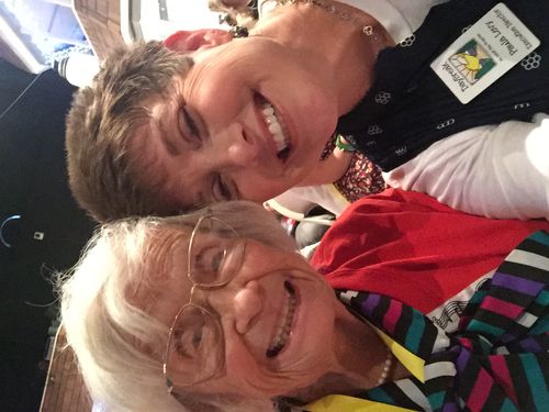 A group of older women standing next to each other