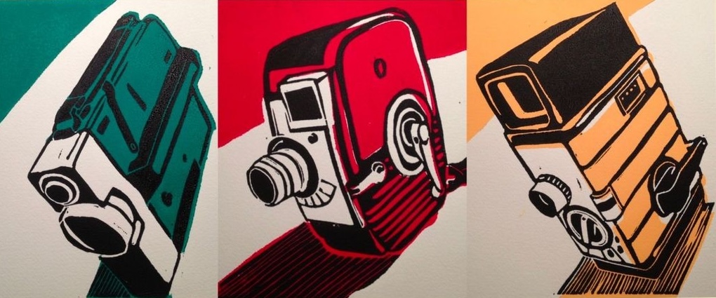 Three block prints of vintage camera designs reproduced using a two colour process. Outlines of the objects were done with black ink with fill colours of teal green for the camera on the left, red for the camera in the centre, and gold yellow for the camera on the right.