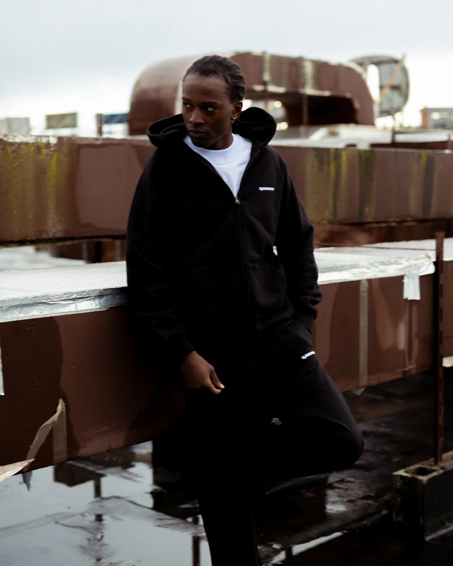 Man wearing a black hoodie on the roof top