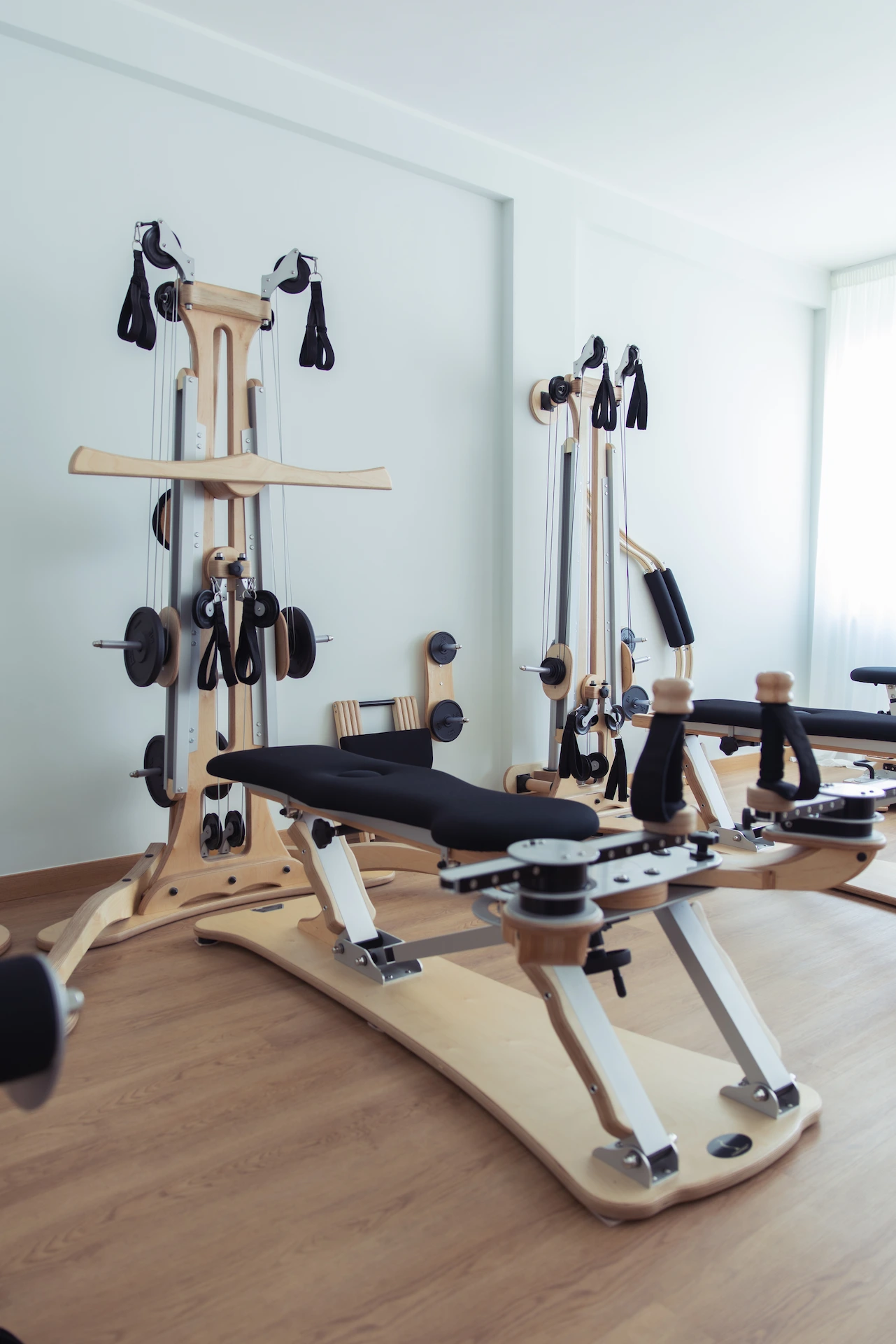 Two young men wearing casual jackets standing on an industrial rooftop with metal structures.