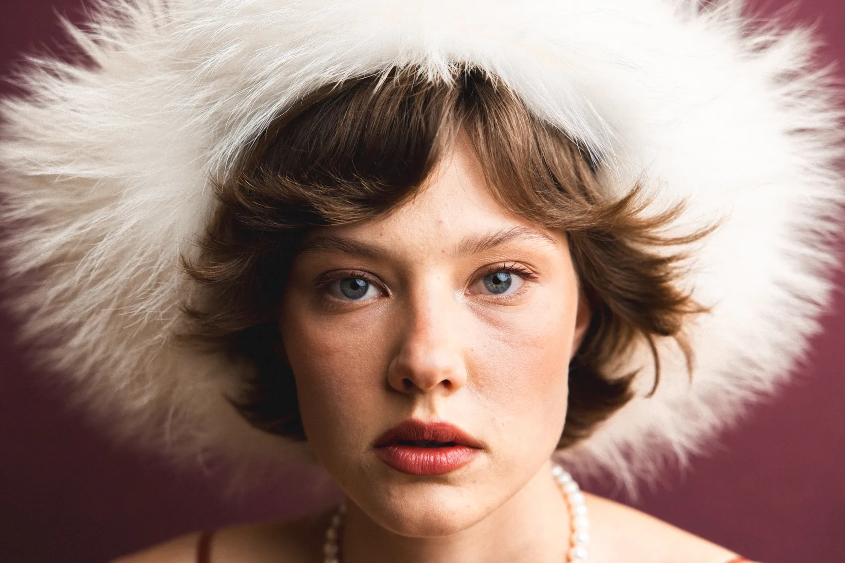 Two young men wearing casual jackets standing on an industrial rooftop with metal structures.