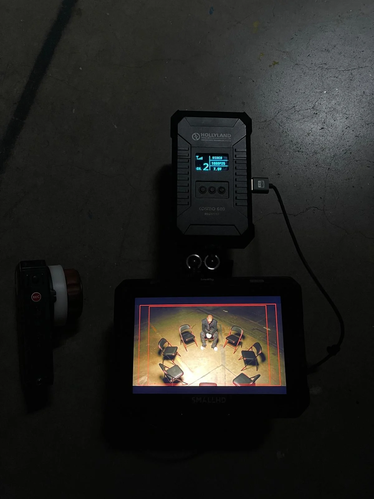 A collage of diverse printed photographs and sketches taped on a gray wall, featuring fashion models, abstract designs, and handwritten notes.