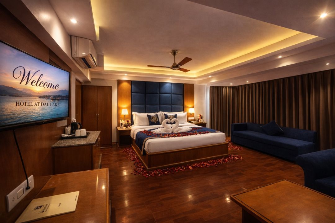 Executive suite at Welcome Hotel Srinagar featuring a spacious layout, plush king-size bed, elegant seating area, and modern luxury interiors.