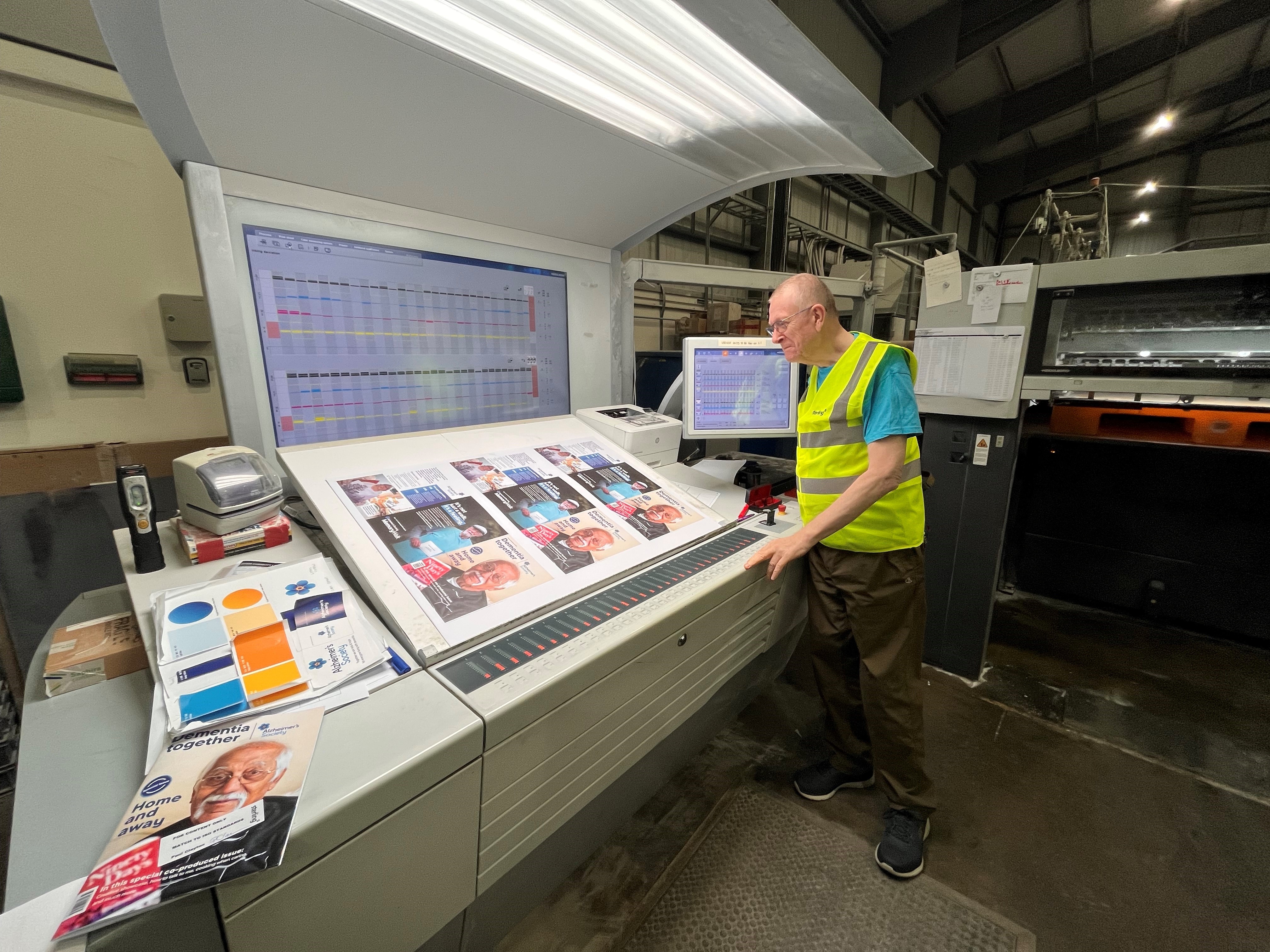 te MIddleton watching the August/September 2023 issue come off the printing press