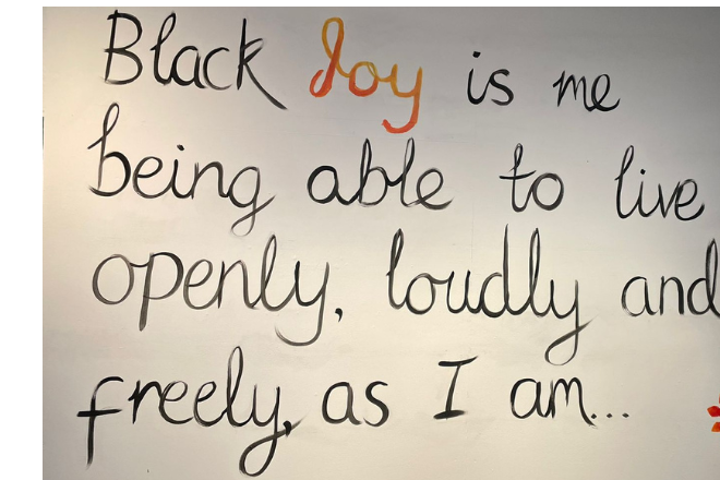 The words ' Black joy is me being able to live openly, loudly and freely as I am' written on a whiteboard. = Photo taken by Issac Samuels.