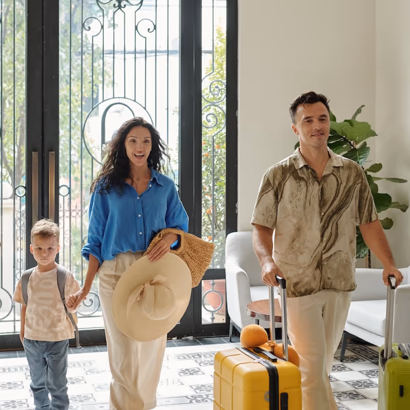 A family walks into a hotel with their luggage
