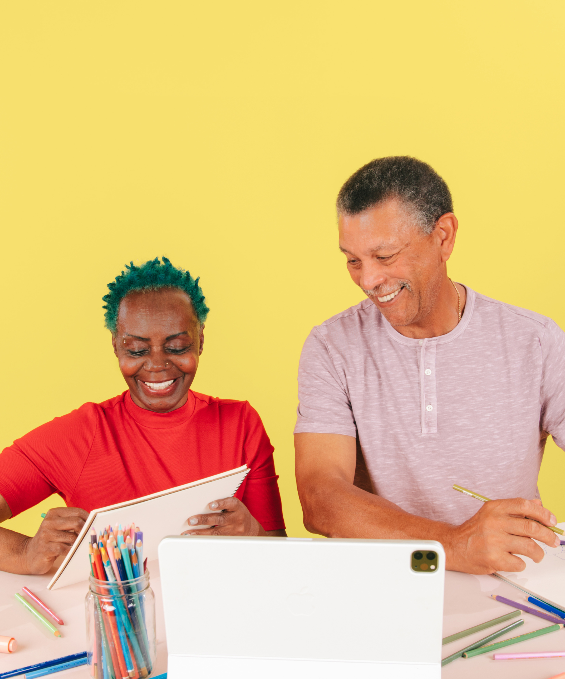 Two older adults connecting over art