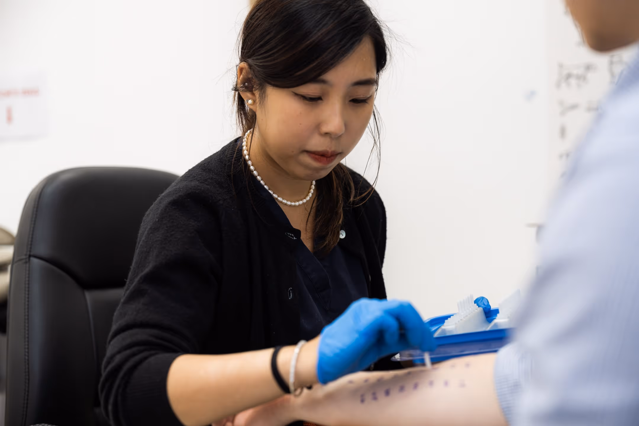 Assistant during a treatment allergy testing procedure