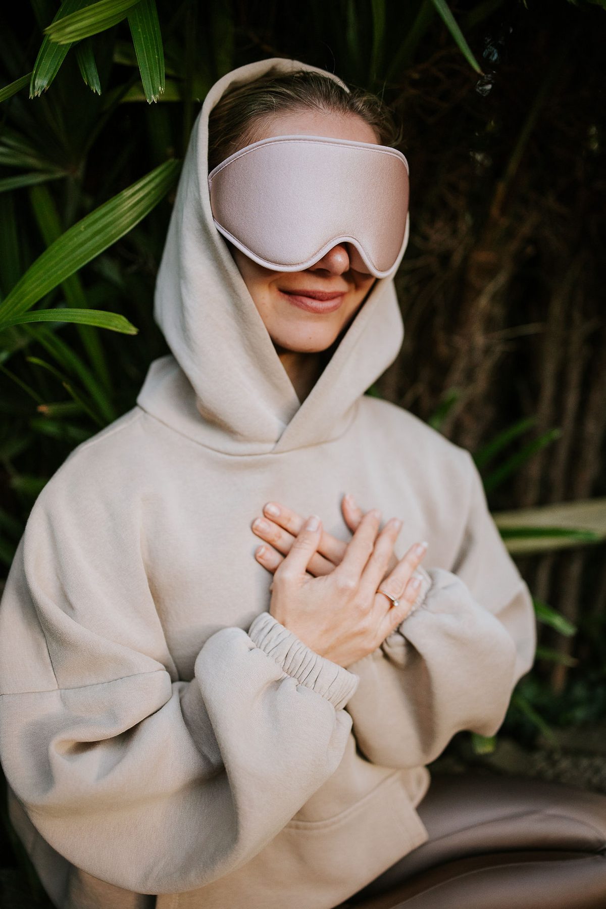 A person wearing the Rose Olo eye mask with hands resting on the chest