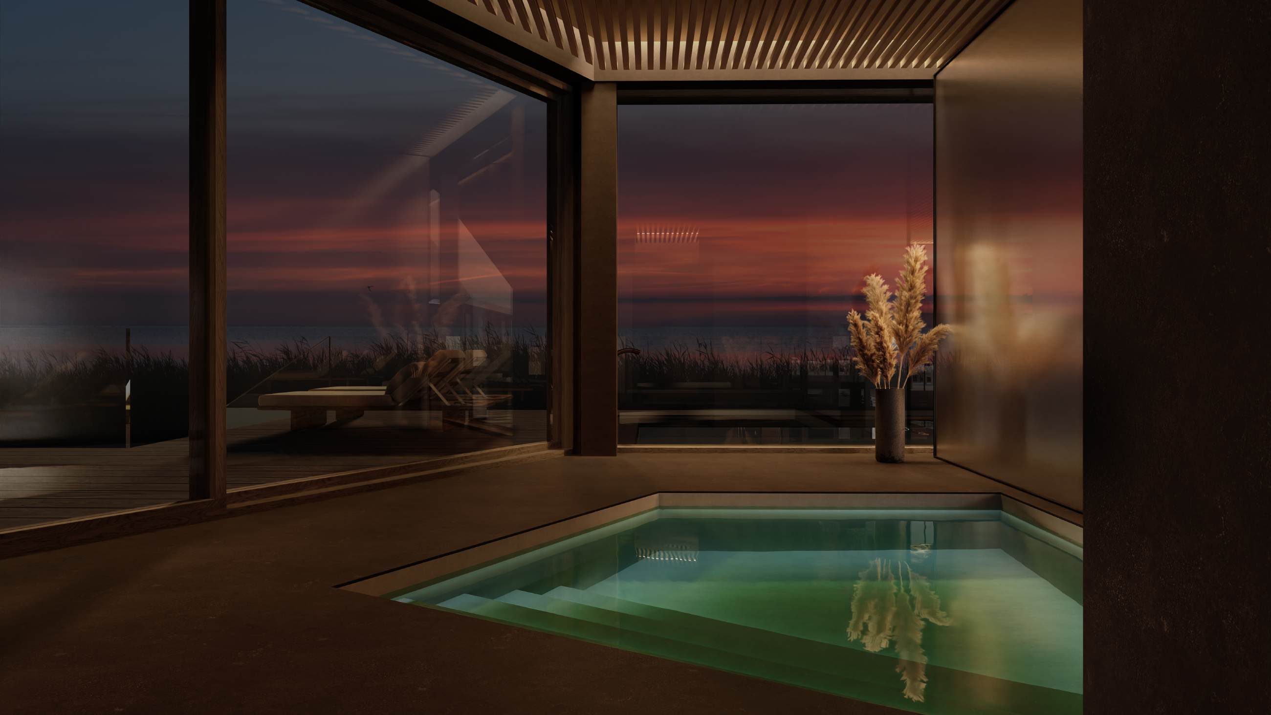 Indoor pool at dusk with a view of the sea and dried grasses