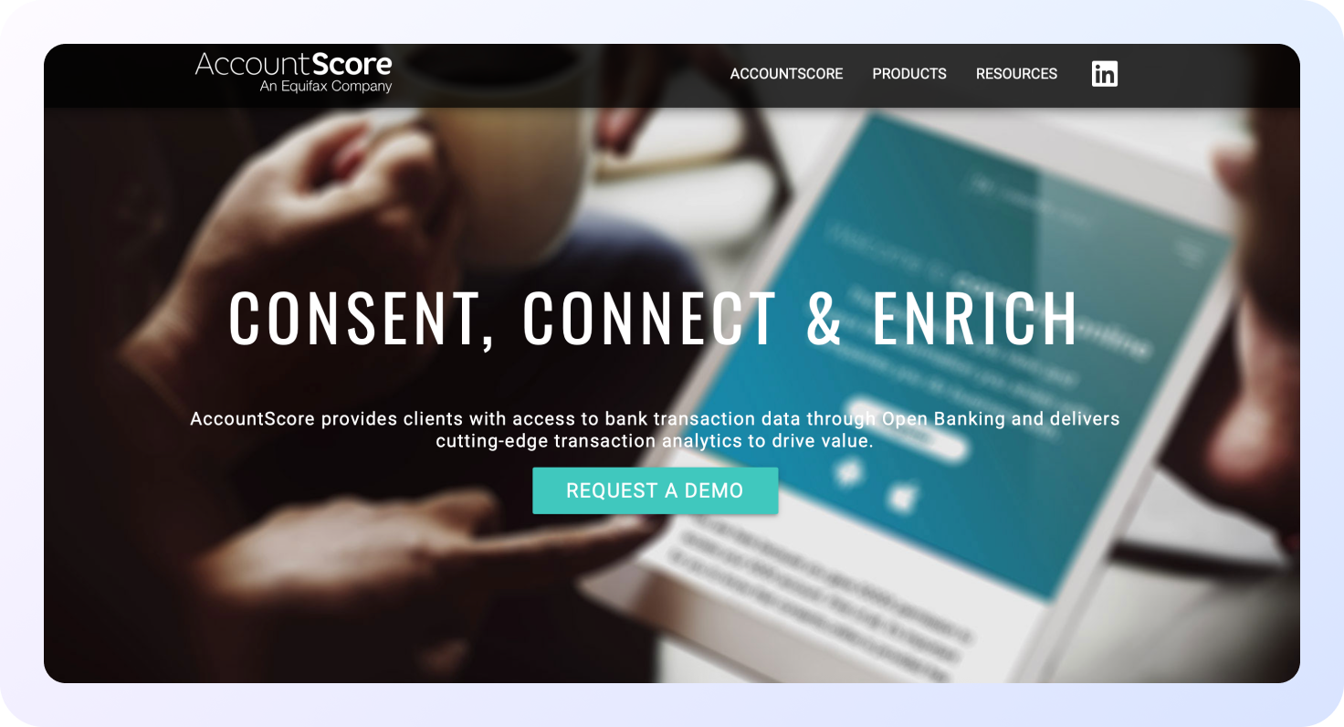 Página de inicio de AccountScore (empresa de Equifax) con el mensaje ‘Consent, Connect & Enrich’, mostrando una tableta con una interfaz financiera y un botón ‘Request a Demo’ sobre análisis de datos bancarios mediante Open Banking.