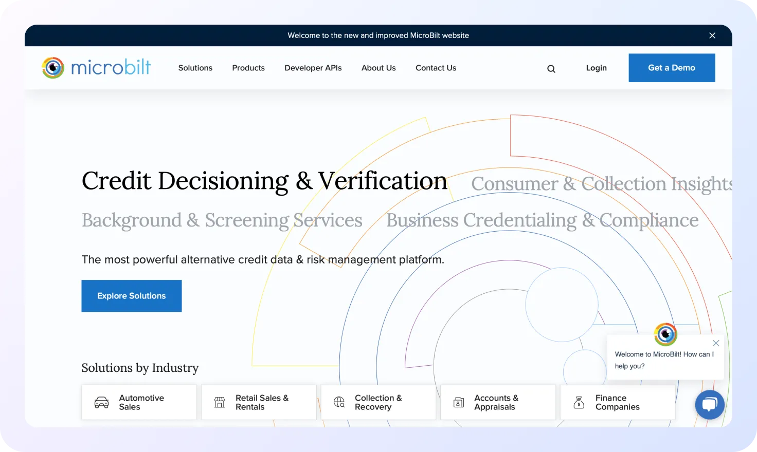 Screenshot of MicroBilt’s homepage showing a banner about credit decisioning and verification, a call-to-action button labeled Explore Solutions, and a list of industry-specific solution categories.