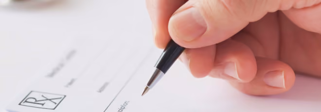 Photo of doctor writing Luminopia prescription