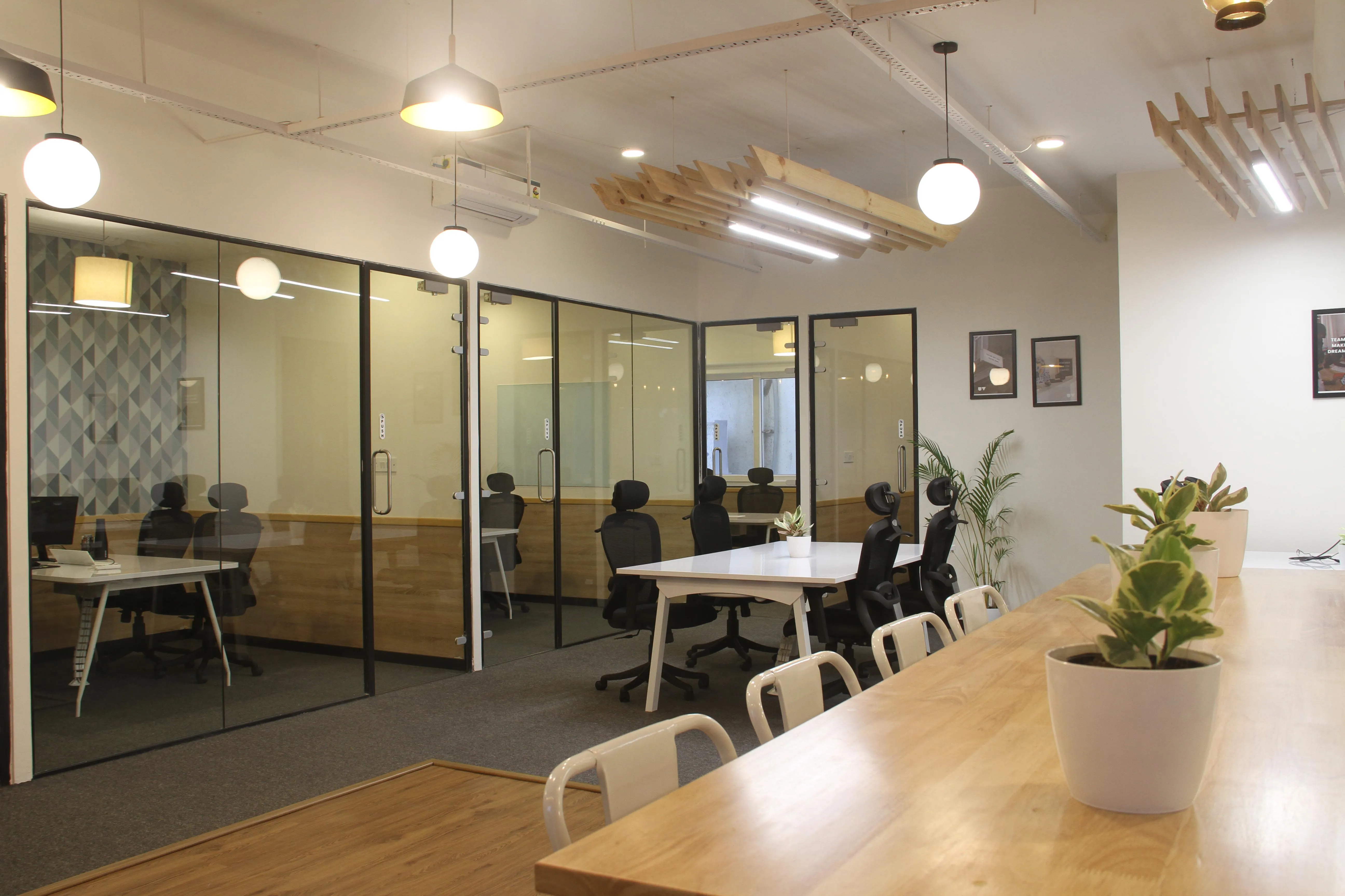 Expansive office space provided by Urban Vault in Bangalore, showcasing separate cabin areas for individual work and a fully equipped conference room.