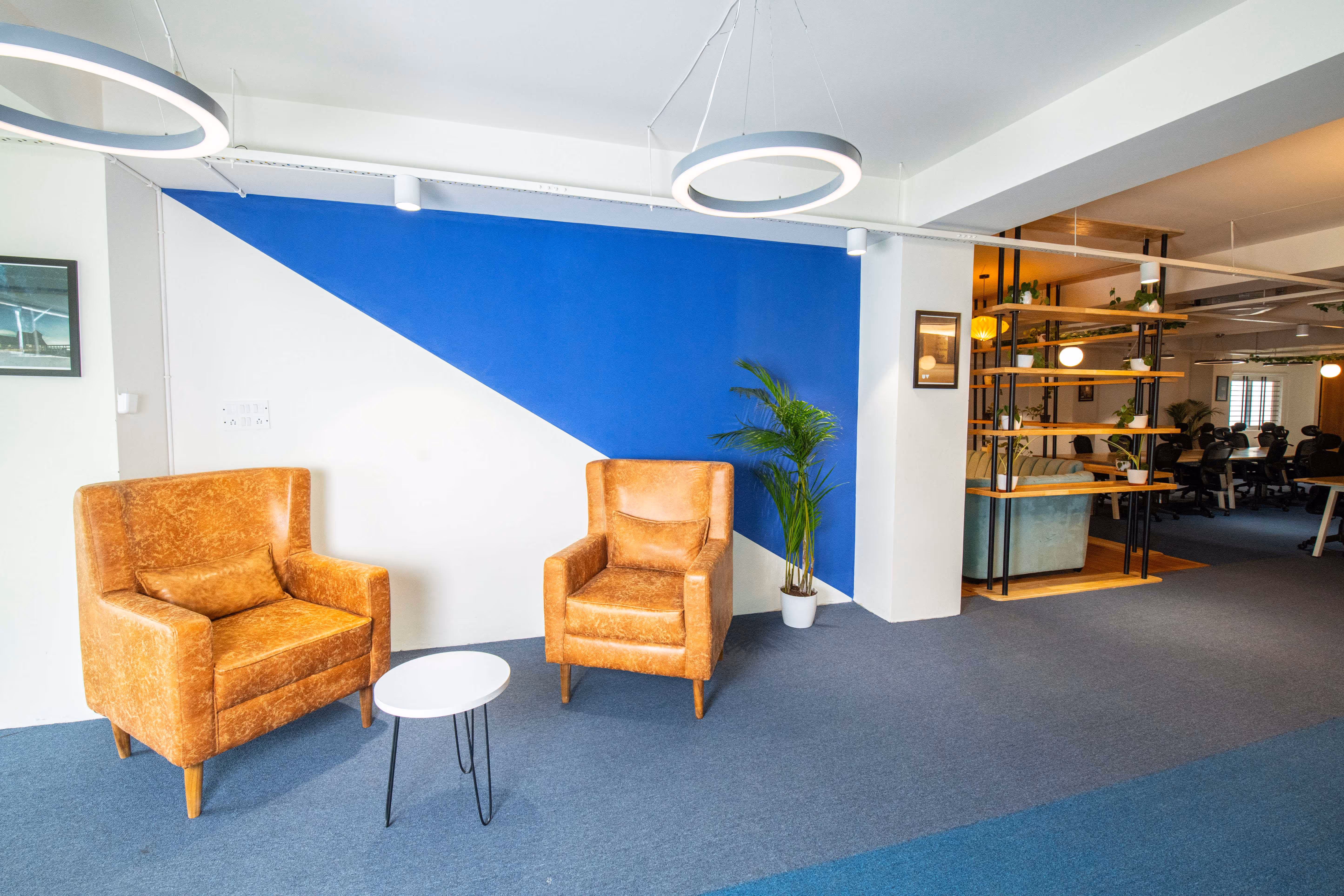an office with chairs and a blue wall