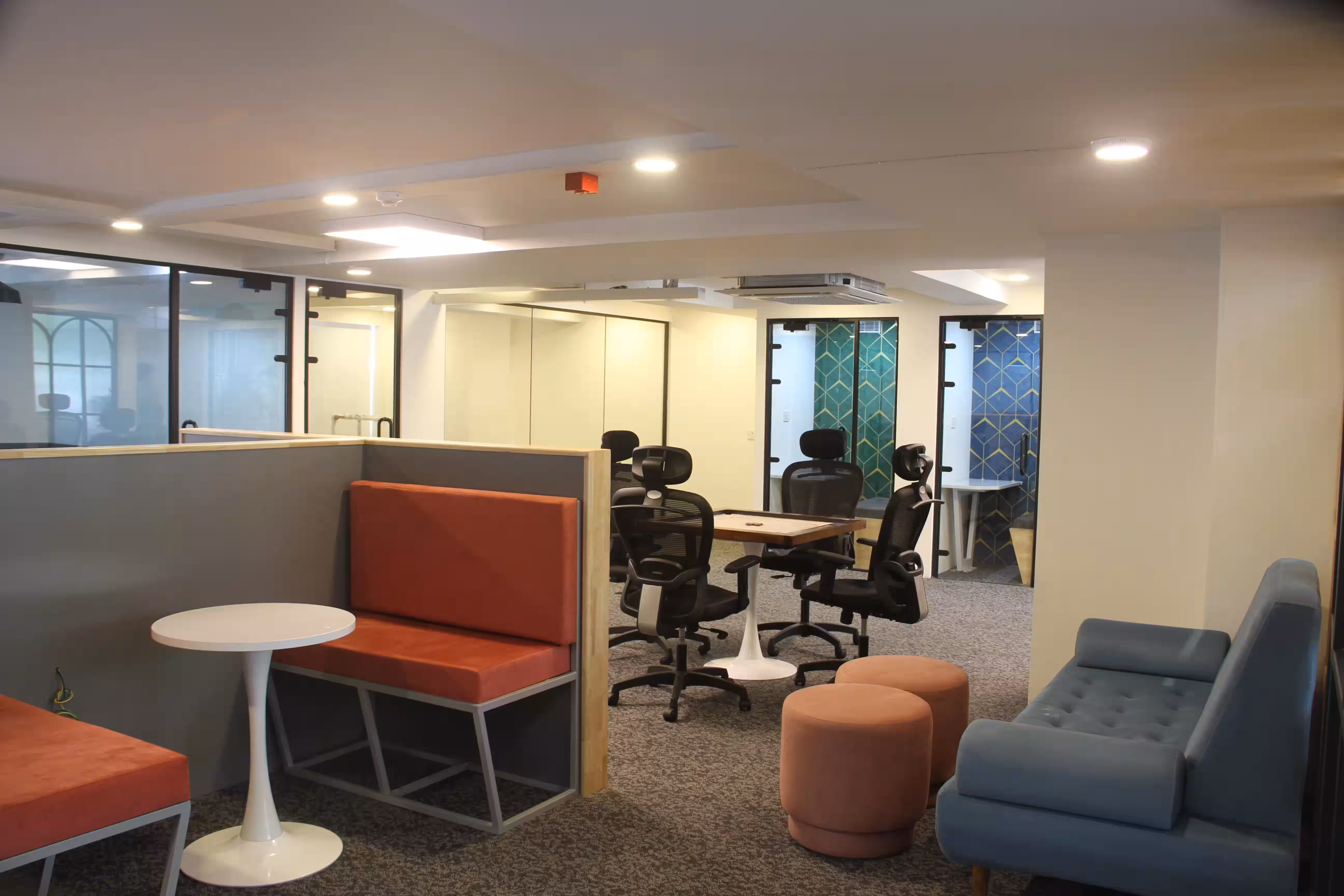 Urban Vault's workspace with desks, booths, and soft seating