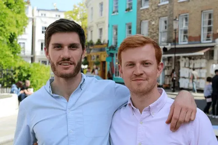 Tom and Llewellyn, co-founders of MakeMyHouseGreen, standing and smiling together outdoors