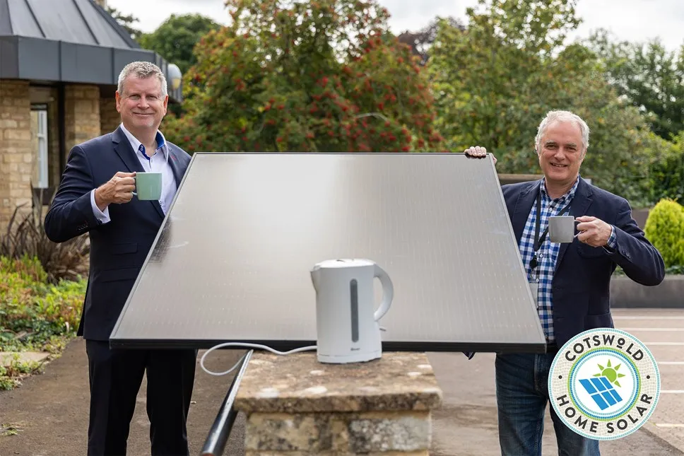 Cotswold District Councillor Mike McKeown holding a solar panel to launch the Cotswold Home Solar Scheme
