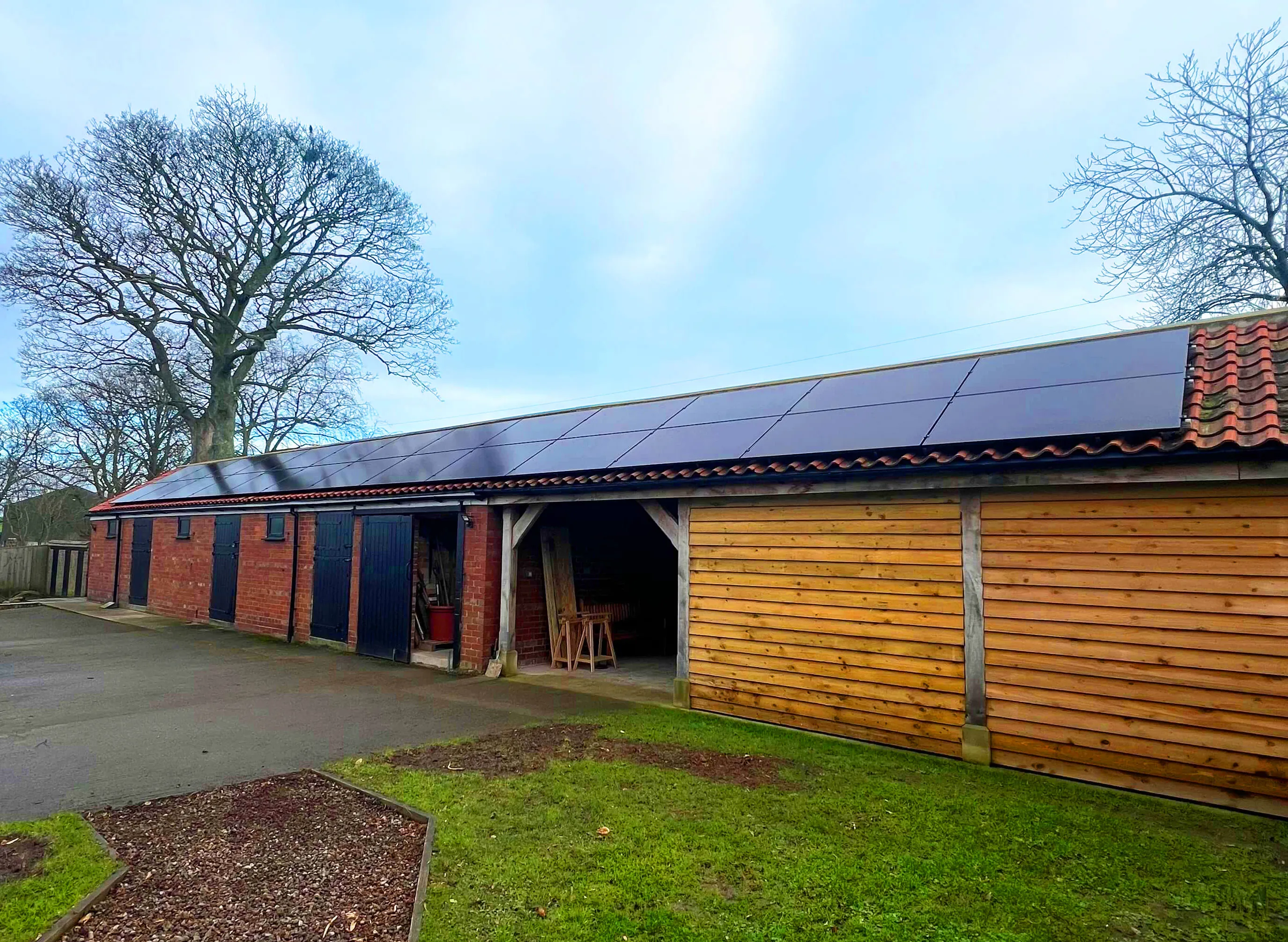 Stables on a farm with solar panels installed on the roof